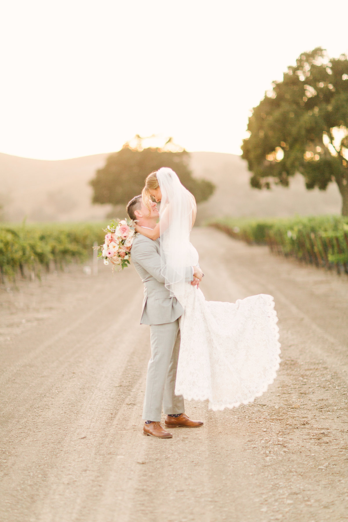 Groom picks up bride at Firestone Vineyard