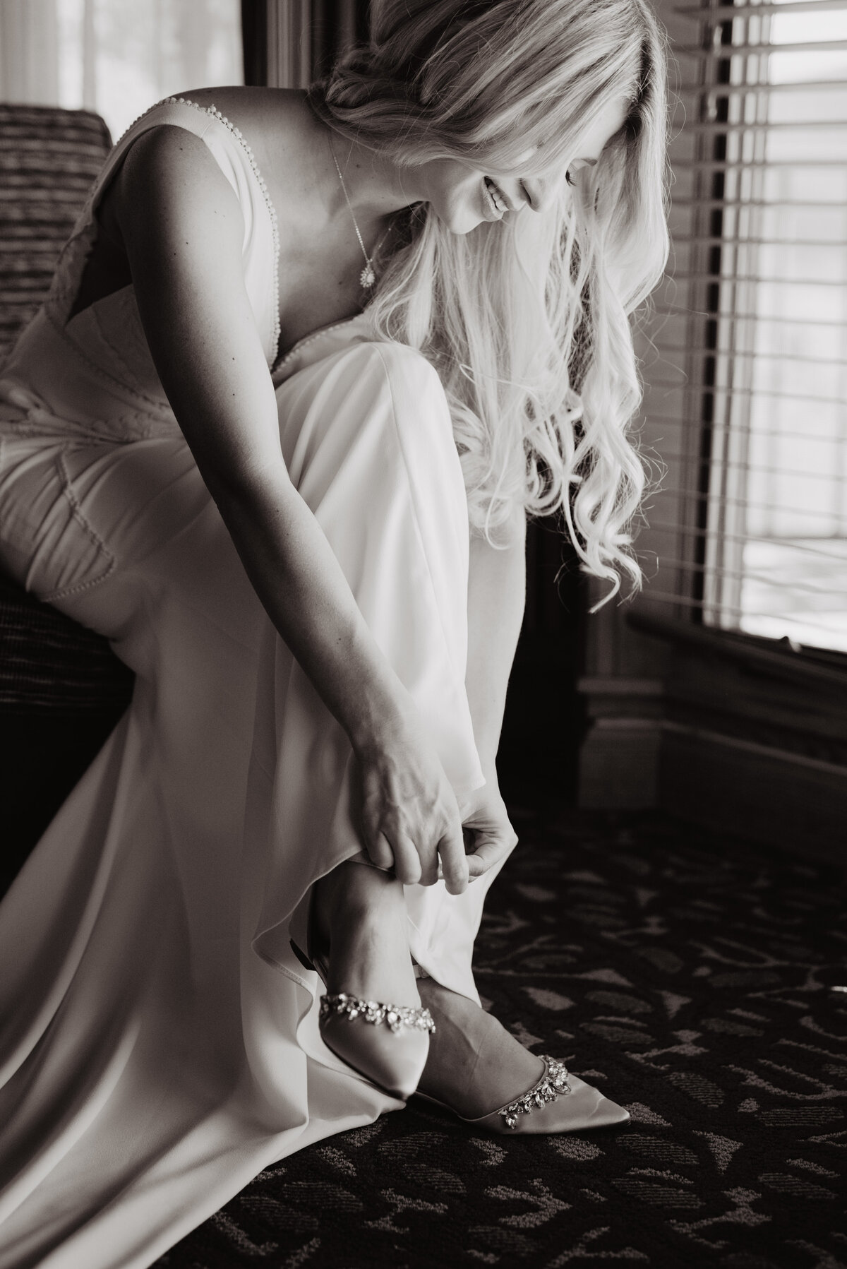 Photographers Jackson Hole capture bride adjusting shoes before Grand Teton wedding