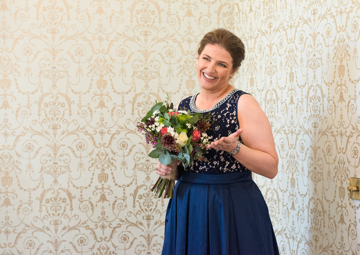 bride in navy wedding dress holding colourful bouquet
