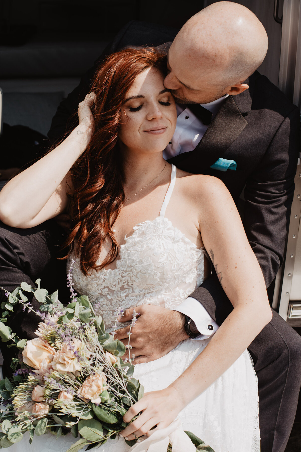 Jackson Hole photographers capture groom kissing bride's forehead