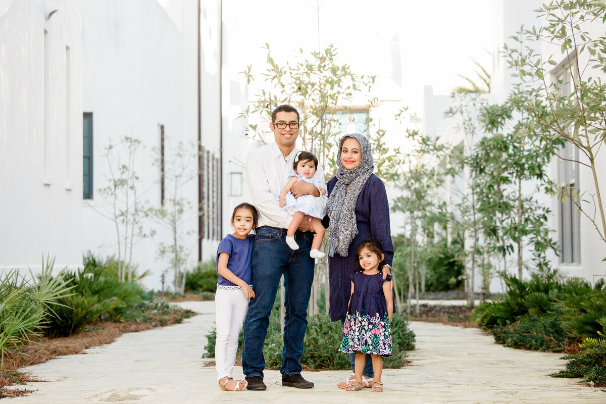 A family standing together in a garden area