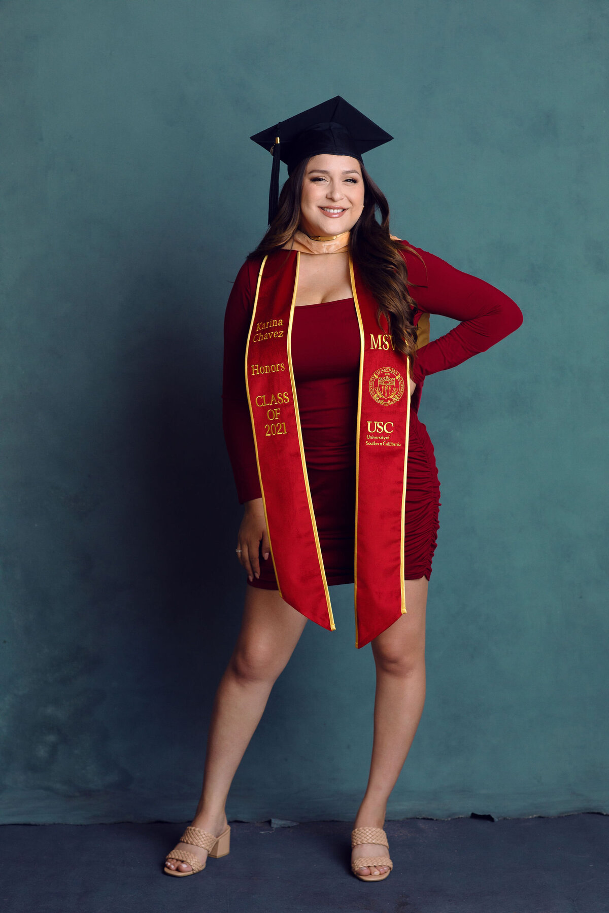 Graduation Portrait Of Young Woman Wearing Red Dress And Black Graduation Cap Los Angeles