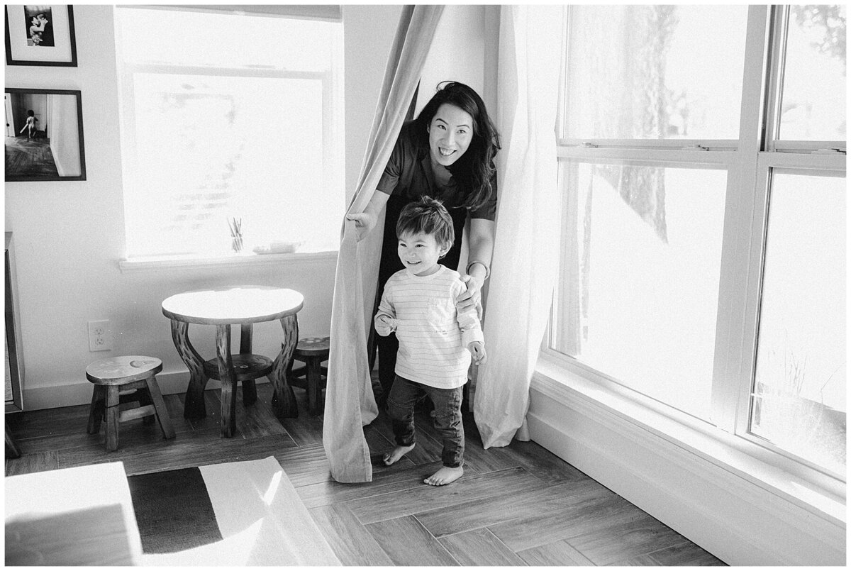 Woman and son hiding in curtains at family photo session in Austin by Amber Vickey Photography