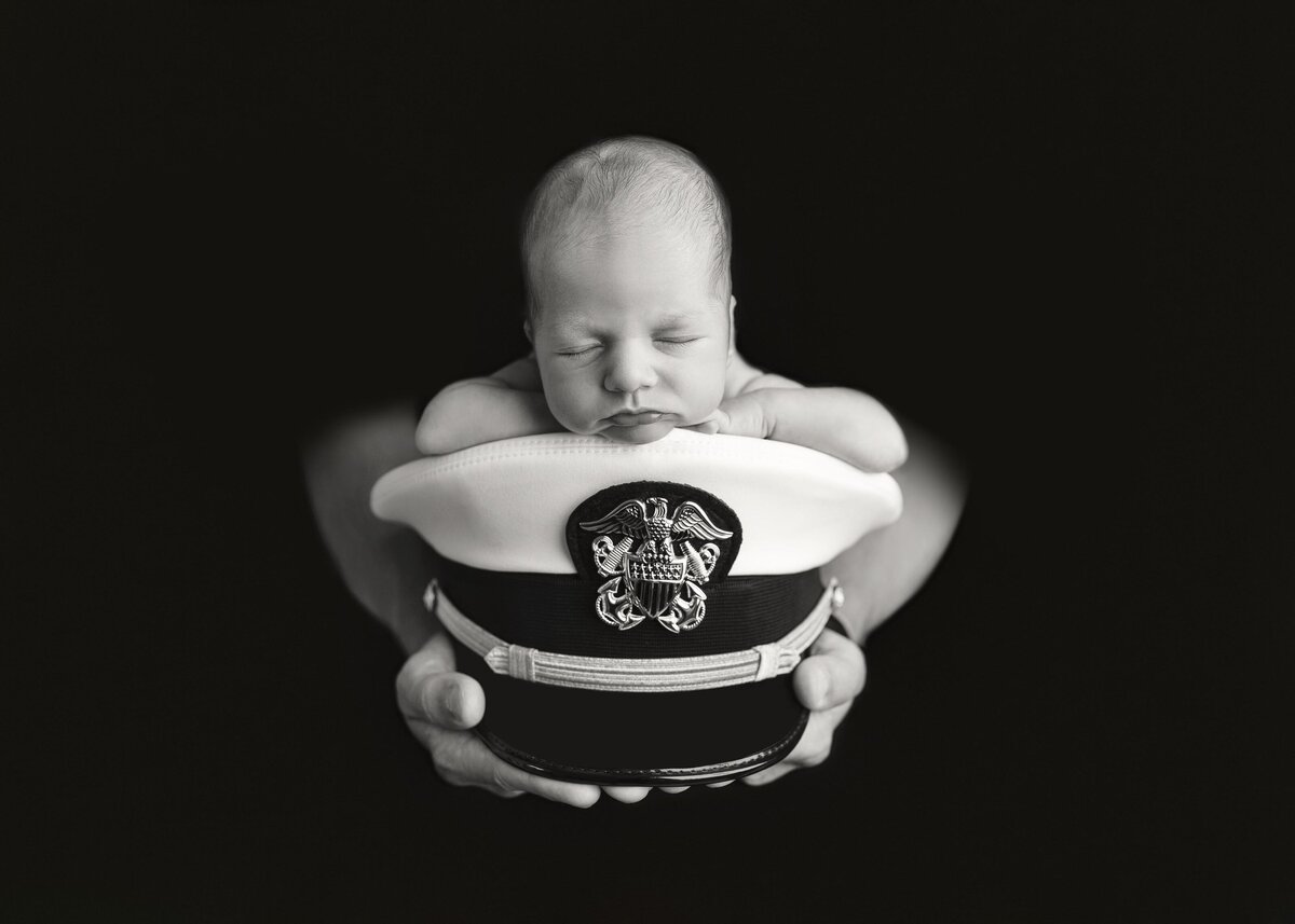 Black and White of Newborn Baby Laying On Air Force Hat