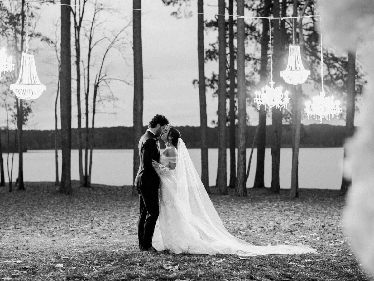 bride and groom outdoor wedding under chandeliers hanging from trees