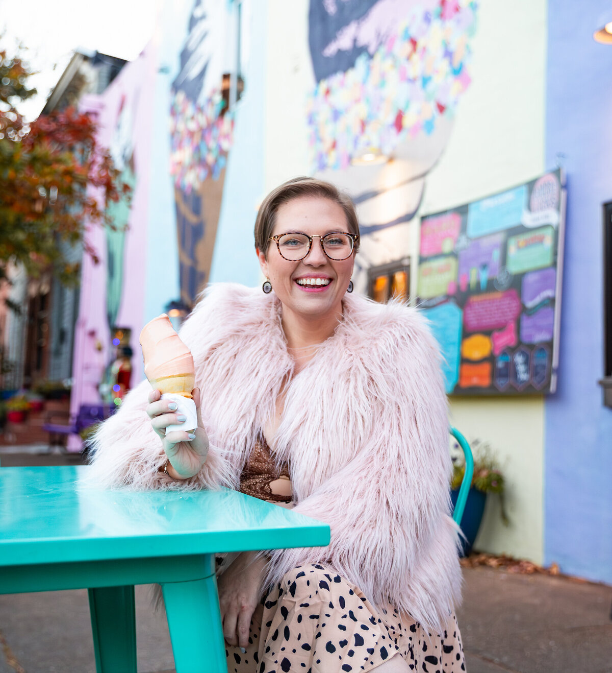 A baltimore small business owner smiles eating ice cream at Bmore Licks in Fells Point.