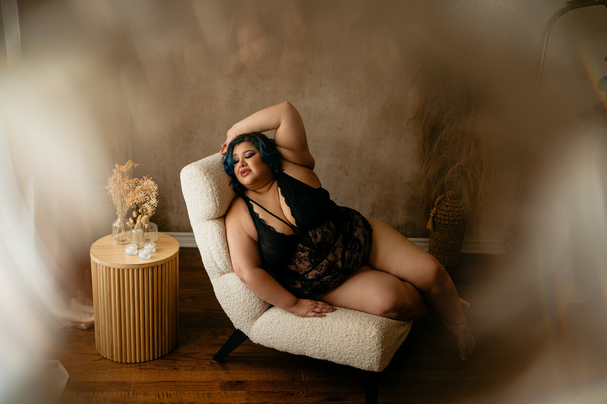 plus size woman on chair in lingerie