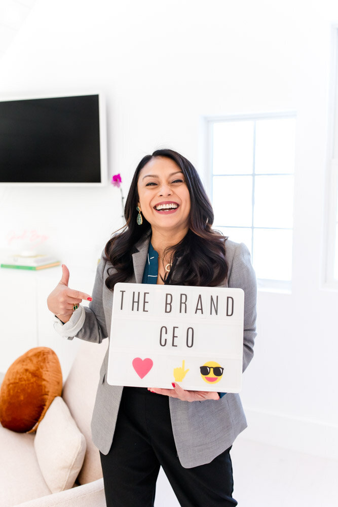 Female entrepreneur with brand CEO sign