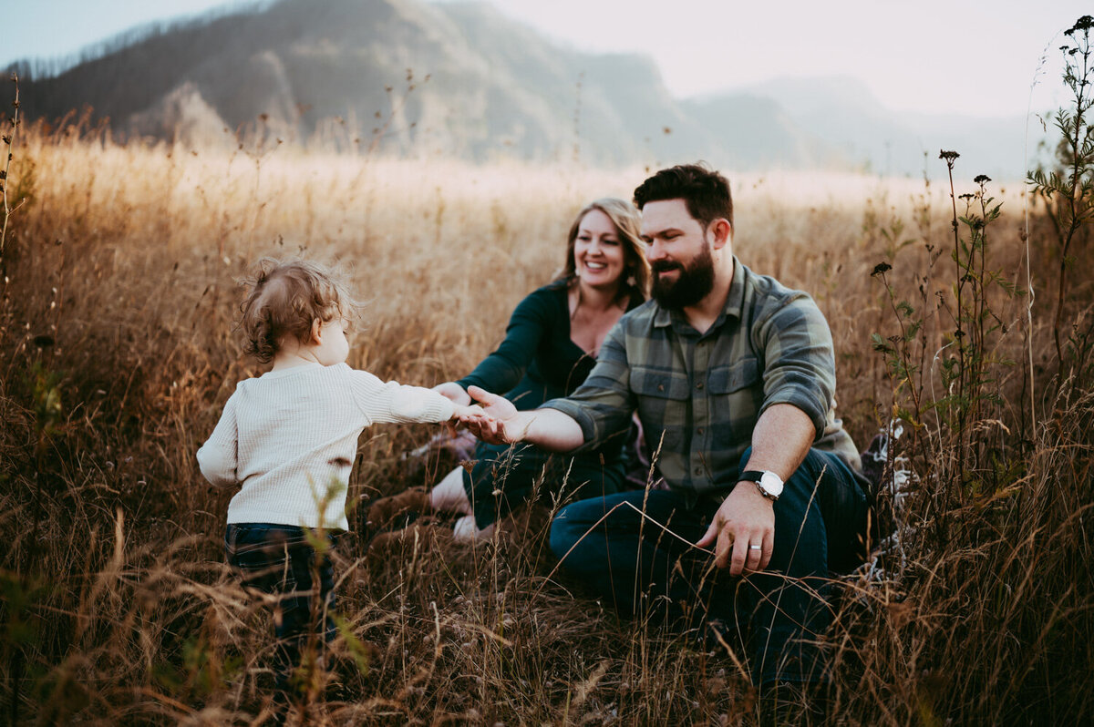 mother and father playing with child