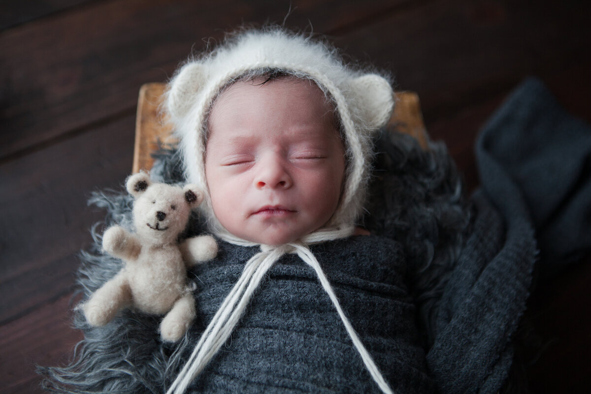 Newborn Baby Boy Wrapped and Snuggled with Teddy Bear
