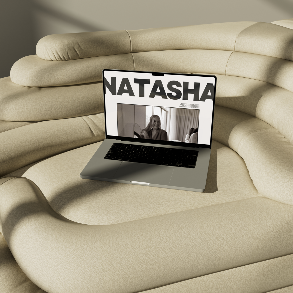 a macbook on a couch with a mockup of business and sales coach natasha zoryk magazine