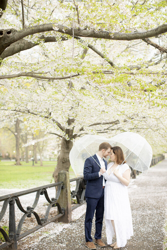 couple poses with umbrellas in Connecticut park