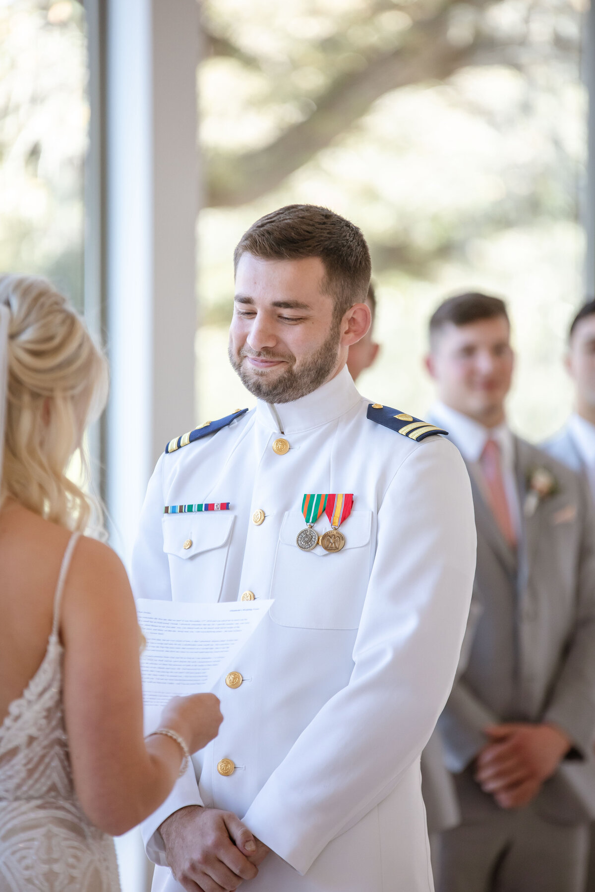 groom in military uniform watches bride read her vows at The Preserve at Canyon Lake Texas wedding