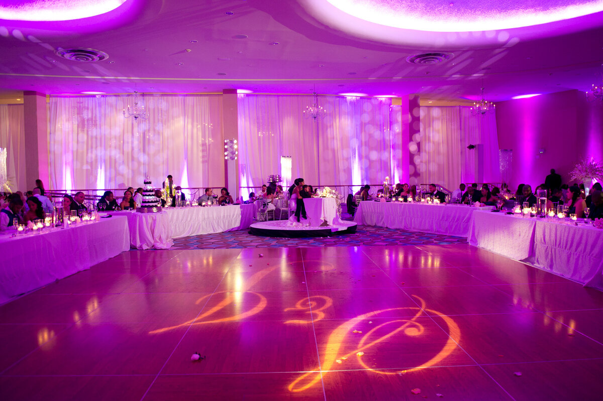 Wedding reception site with a grand dance stage and guests beside