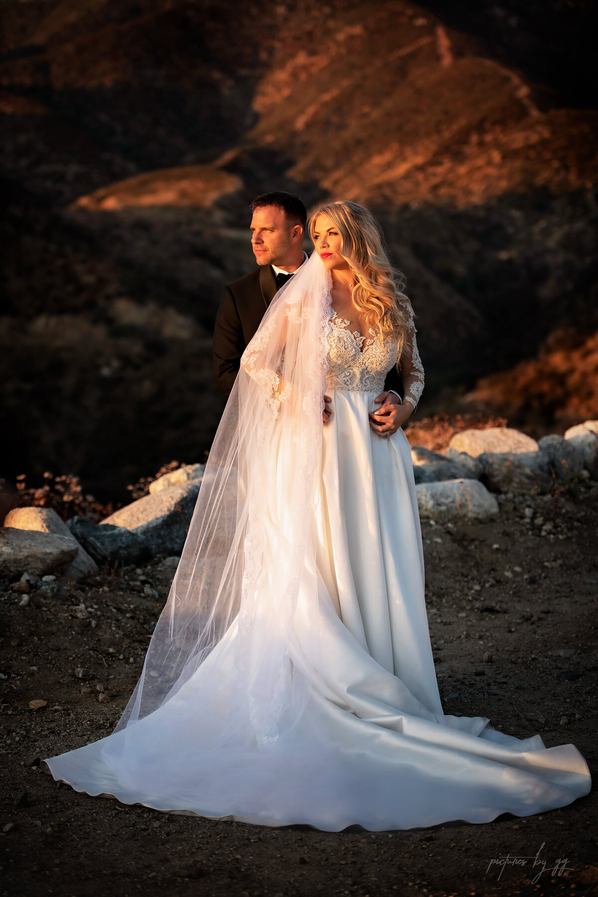 Bride and groom lit up by golden light in Serendipity Garden California surrounded by mountains