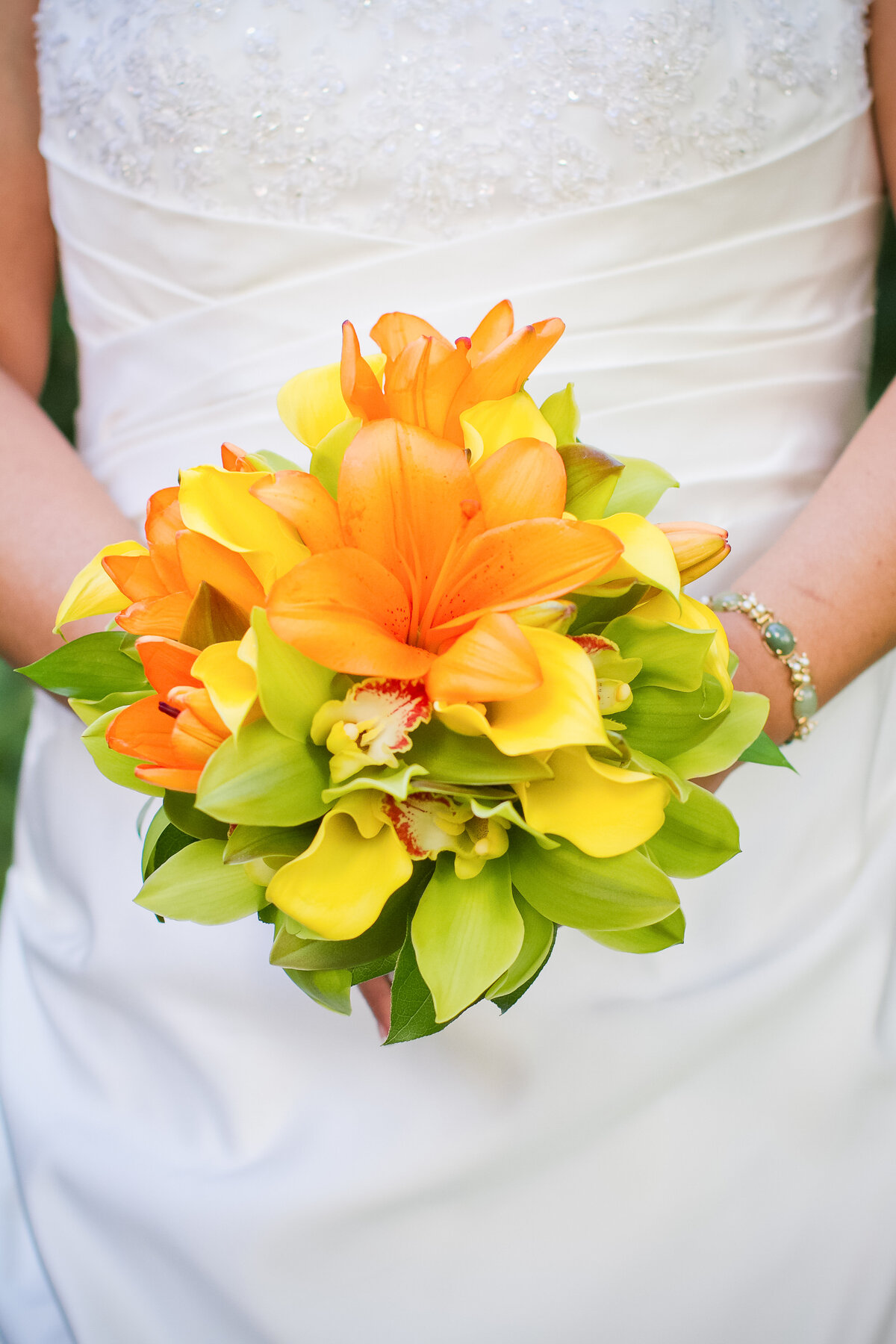 Photo of a Tropical Wedding Bouquet in Oranges, Greens and Yellow