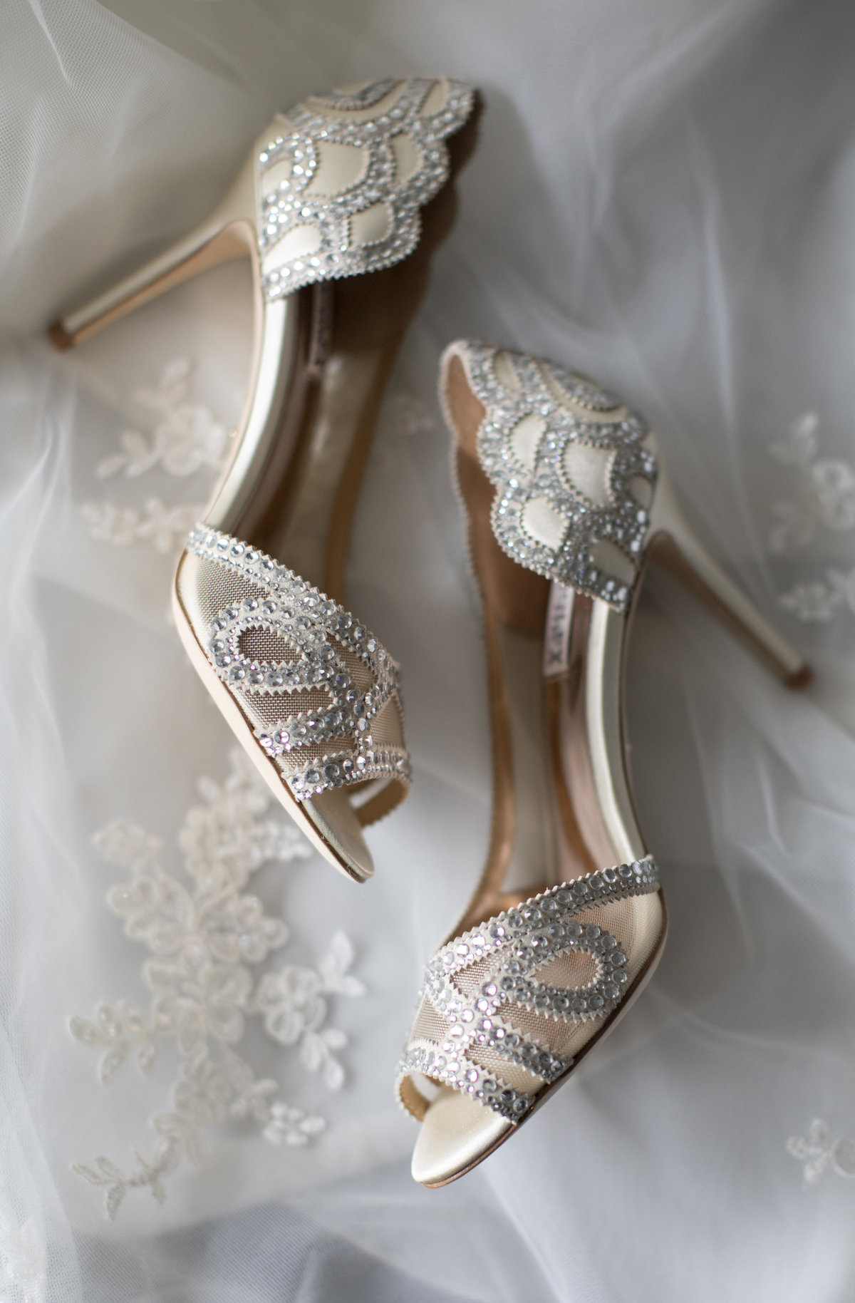 shoes laying on wedding dress before clarks landing yacht club wedding