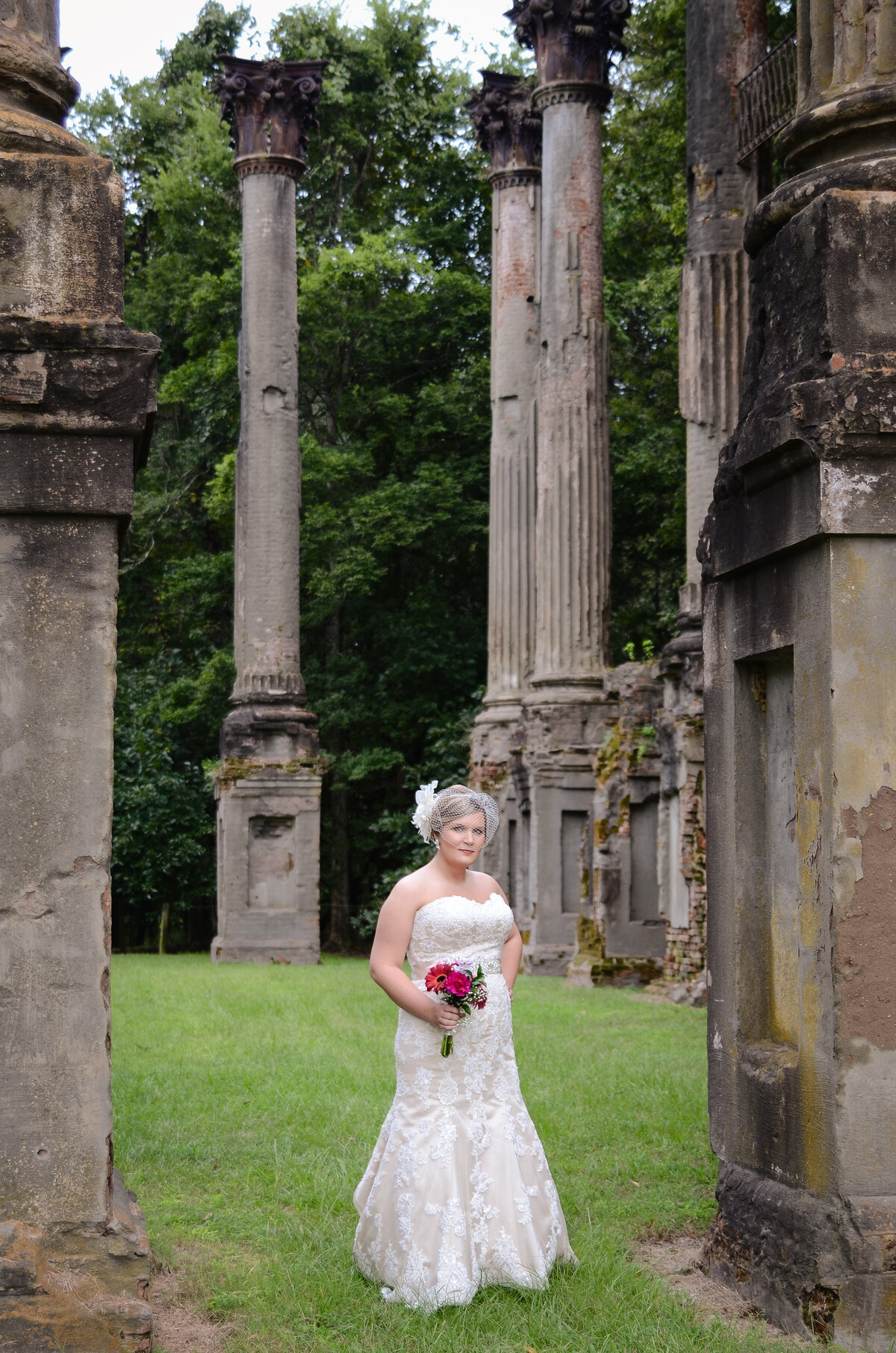 Beautiful bridal portrait photography: bride in vintage gown with birdcage veil among the ruins at Windsor plantation in MS