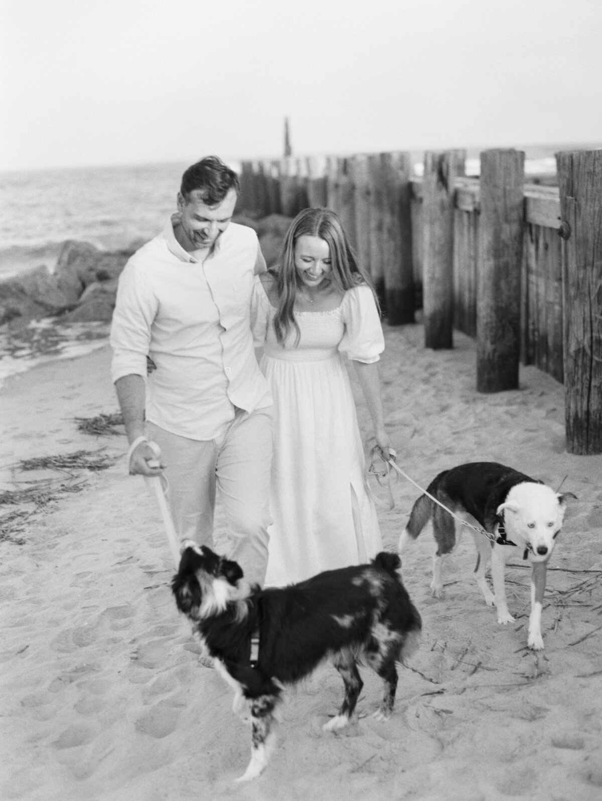 Black and white engagement photos on the beach in Charleston. This couple brought their dogs for their photos. Kailee DiMeglio Photography. Black and white engagement photos.