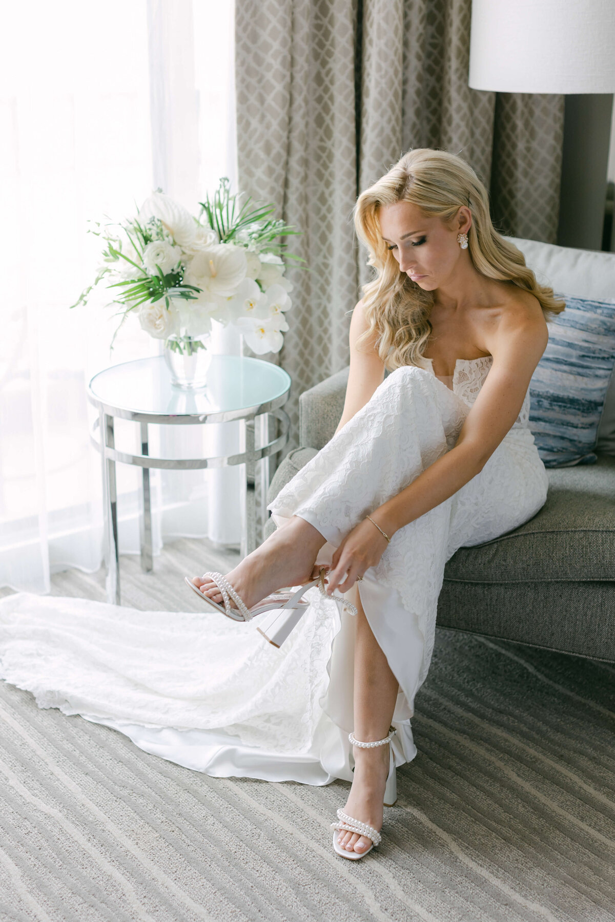 A bride puts on her heels.