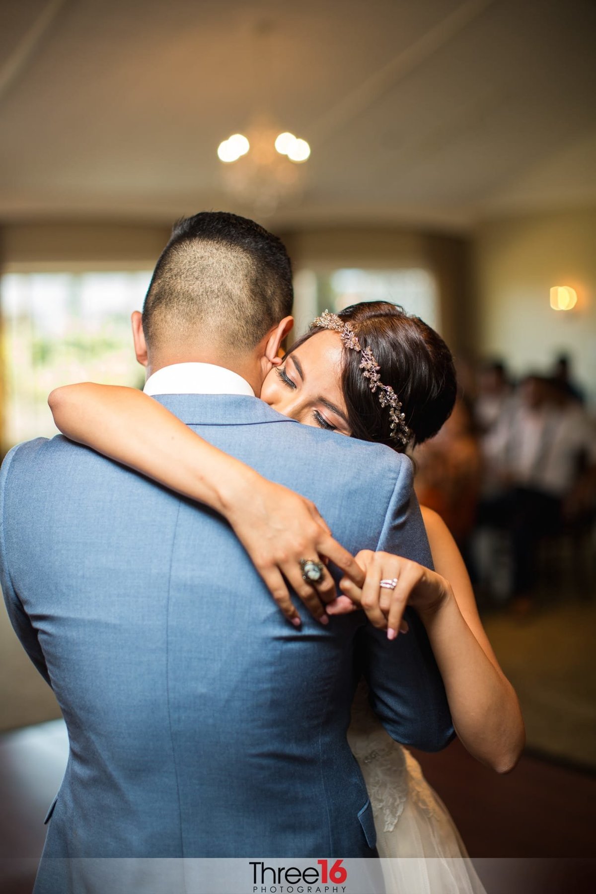 Bride and Groom fully embrace each other during their first dance