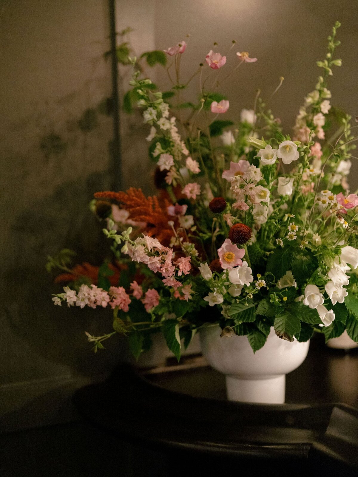 flower arrangement in white ceramic vase