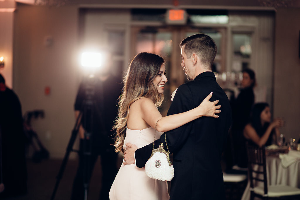 Wedding Photograph Of Groom In Black Suit Hugging a Woman In White Dress Los Angeles