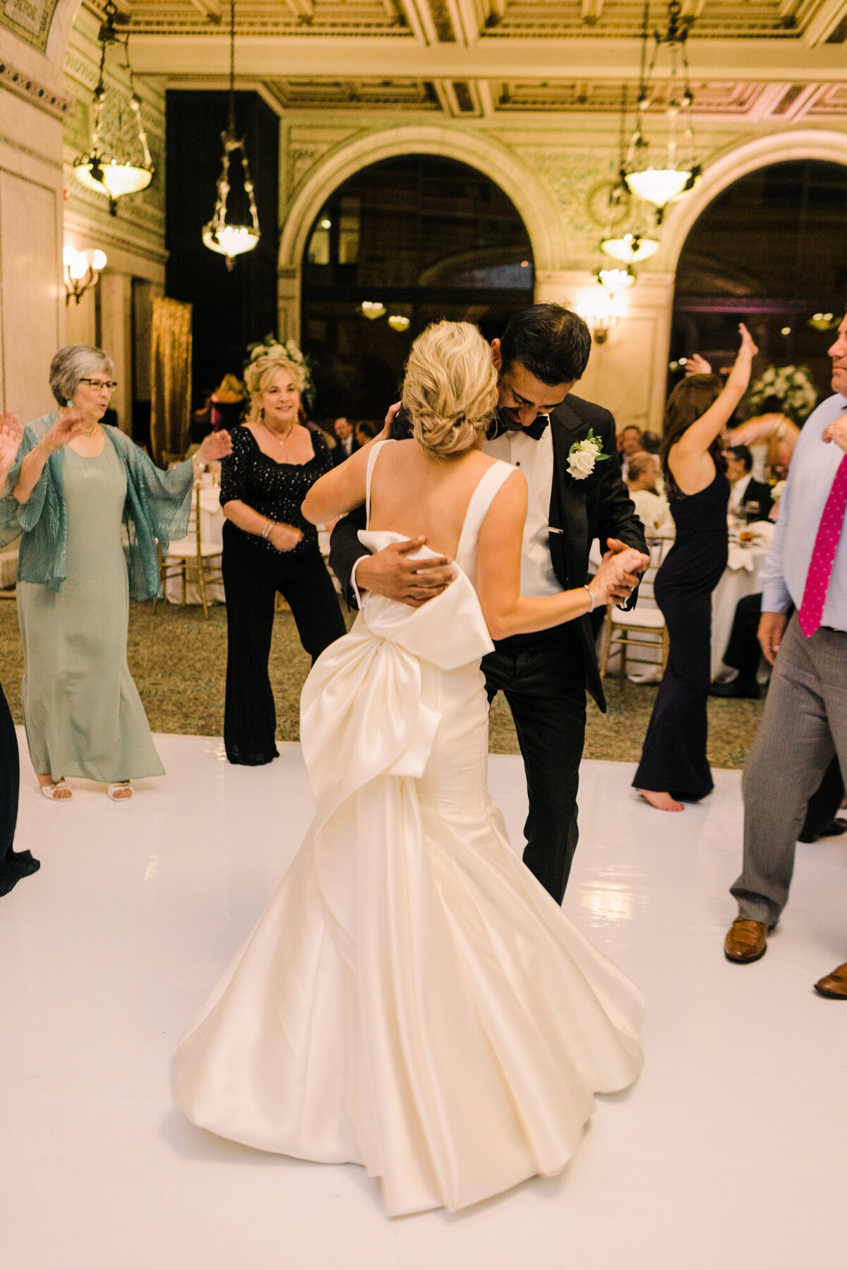 Newlyweds share a dance at their wedding reception at the Chicago Cultural Center
