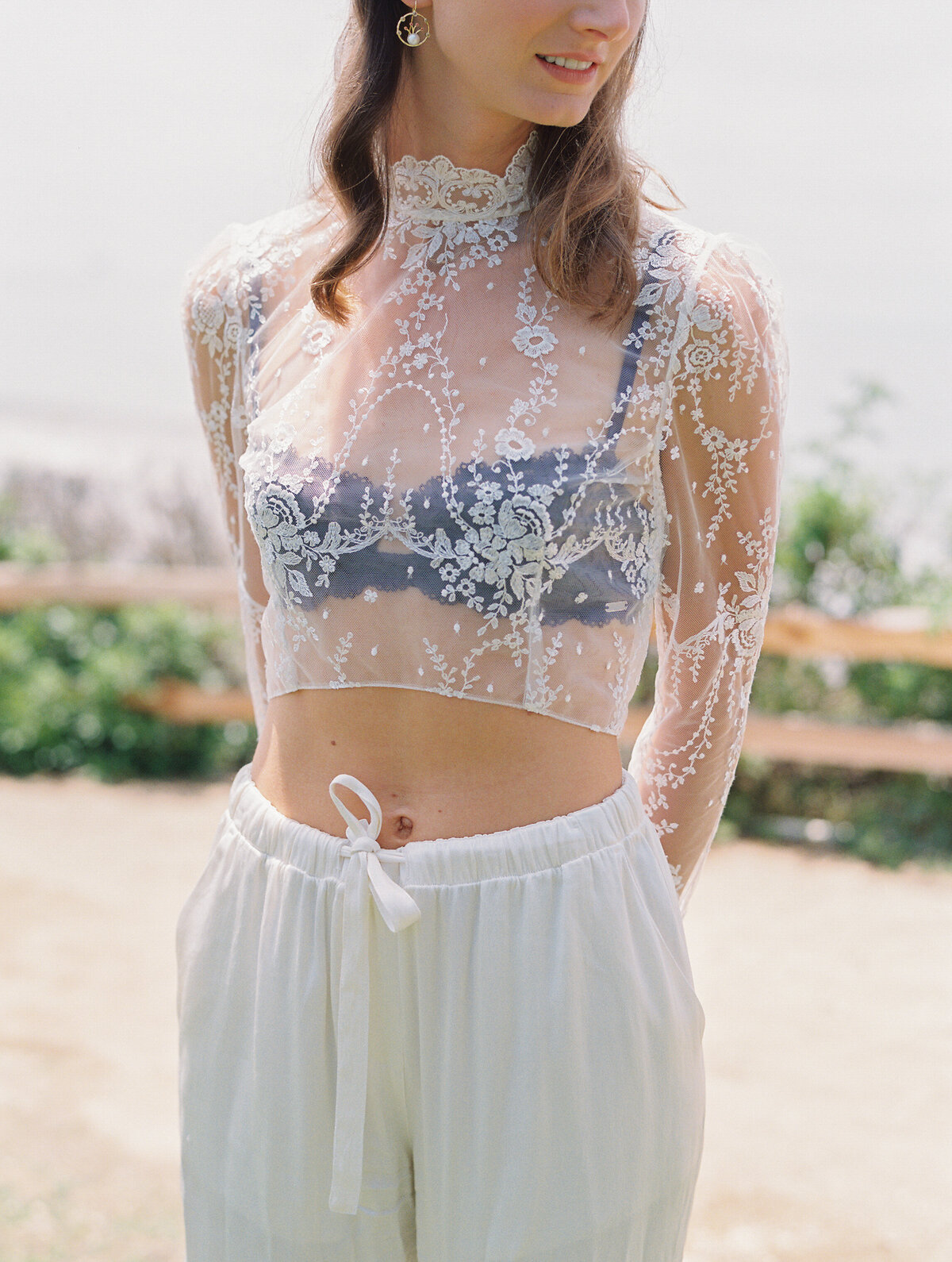 sheet lace crop top from Elizabeth Fillmore with black bra underneath
