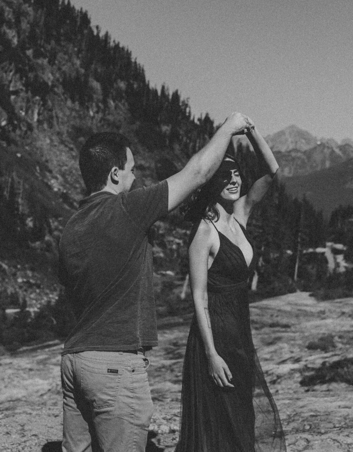 A couple dancing on a cliff during their engagement session at Heather Meadows on Mount Baker.