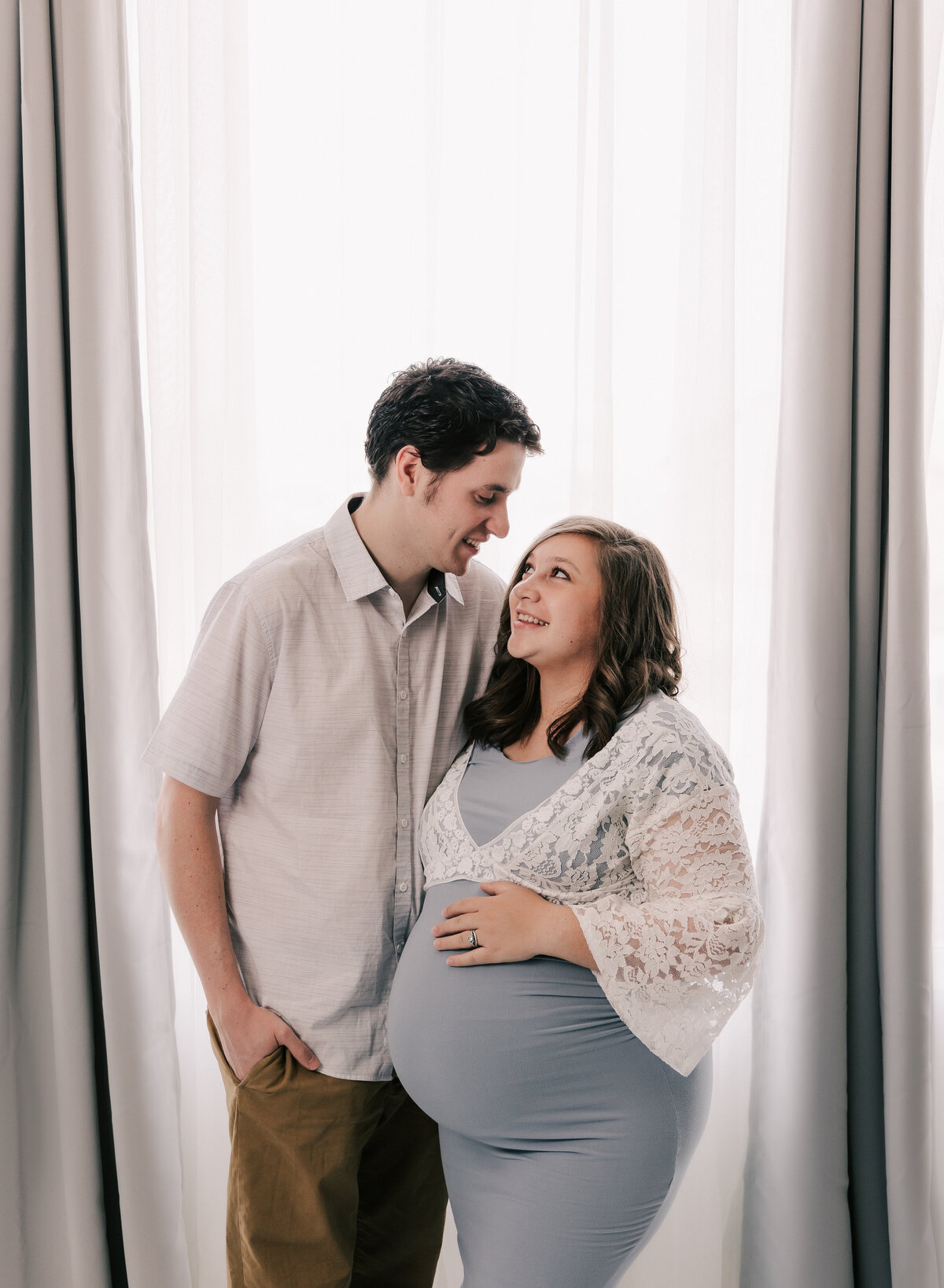 A cute young couple during their maternity photo shoot at Diane Owen Photography studio.