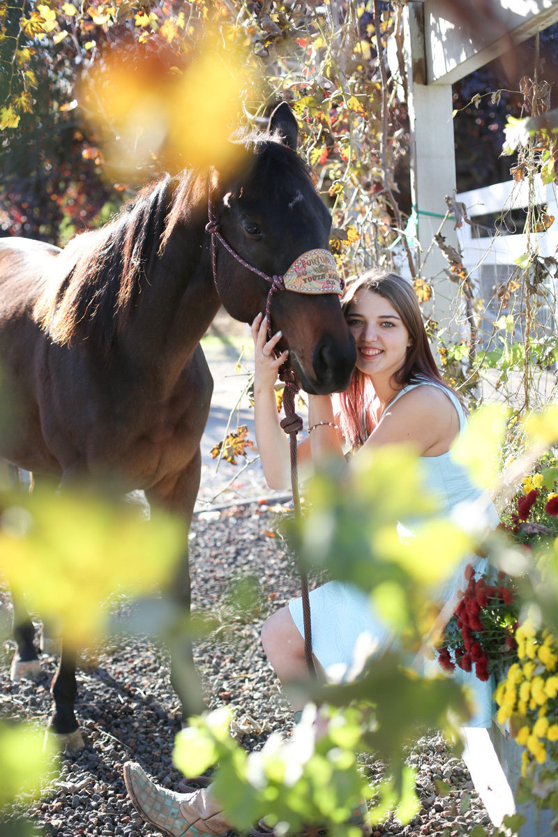girl with horse in flowers