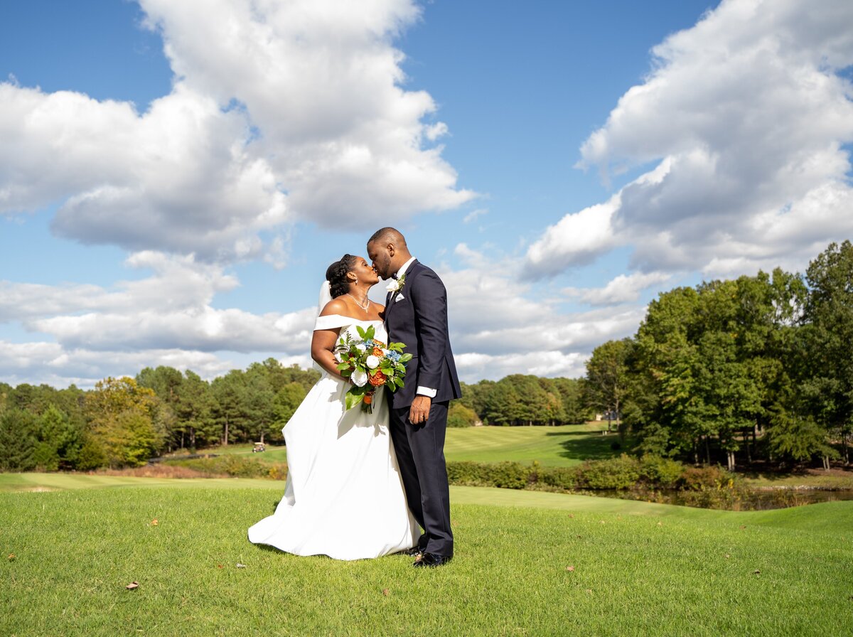 Couple shares a kiss after exchanging nuptials at Fawn Lake Country Club in Virginia