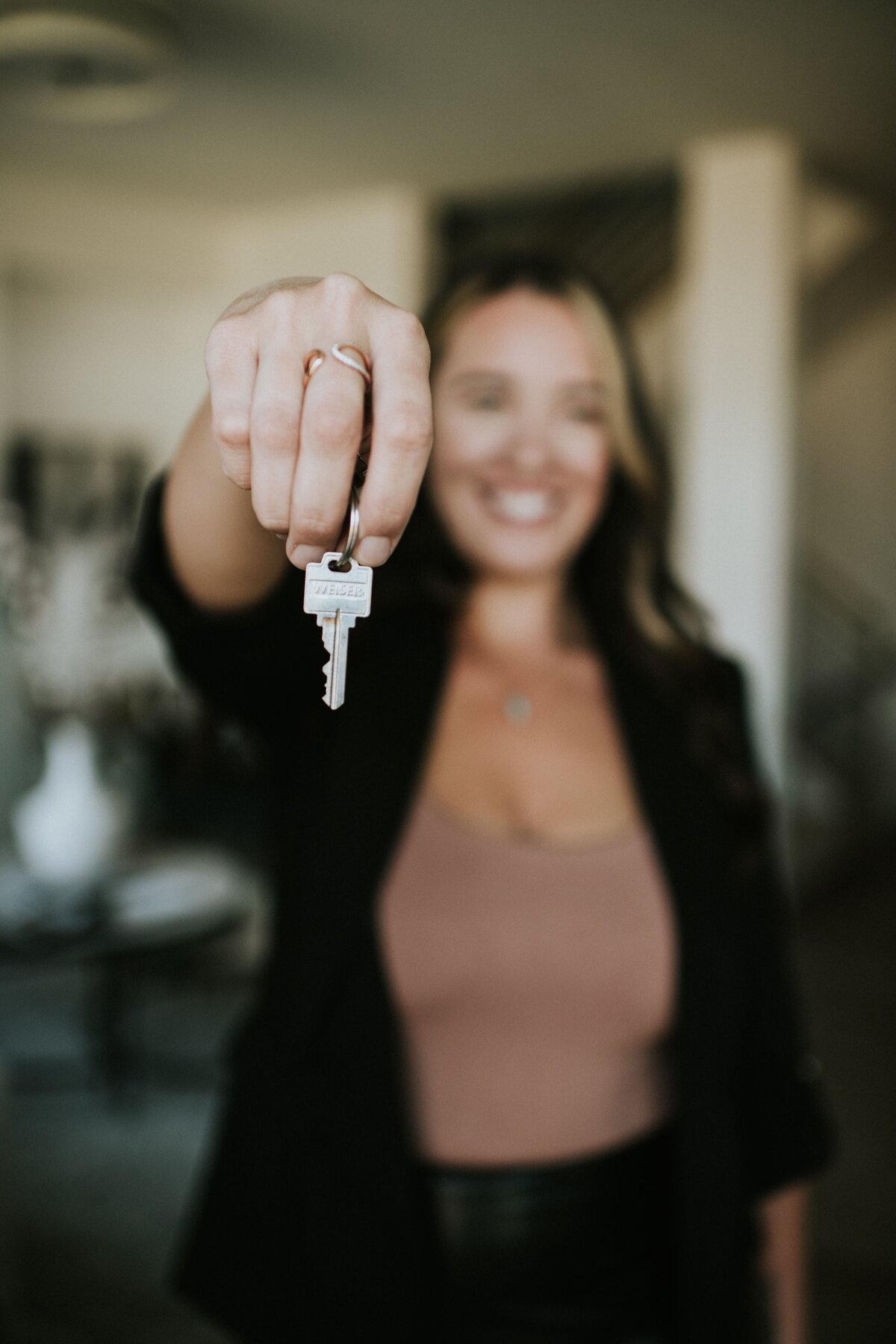 woman holding keys real estate