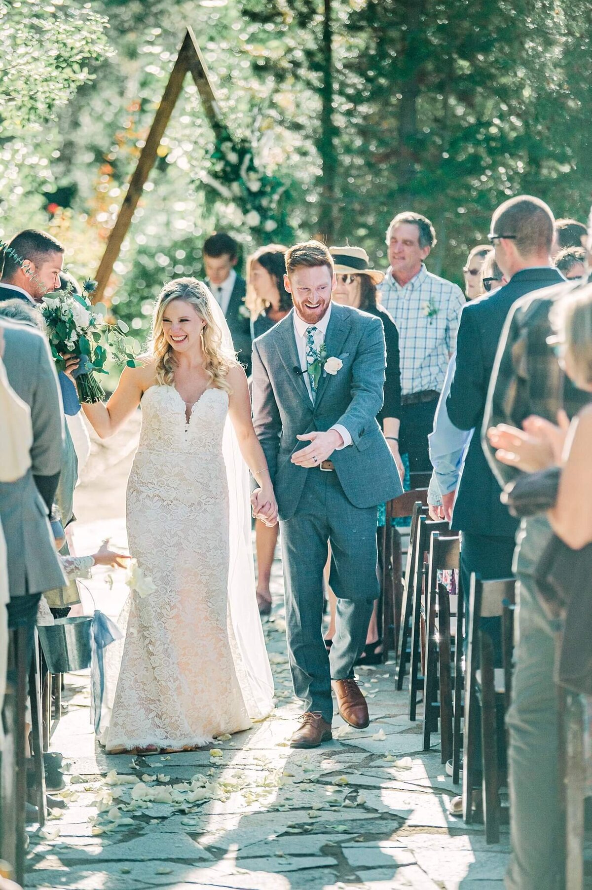 Happy couple walking off the aisle Just Married at PlumpJacks Palisades Tahoe