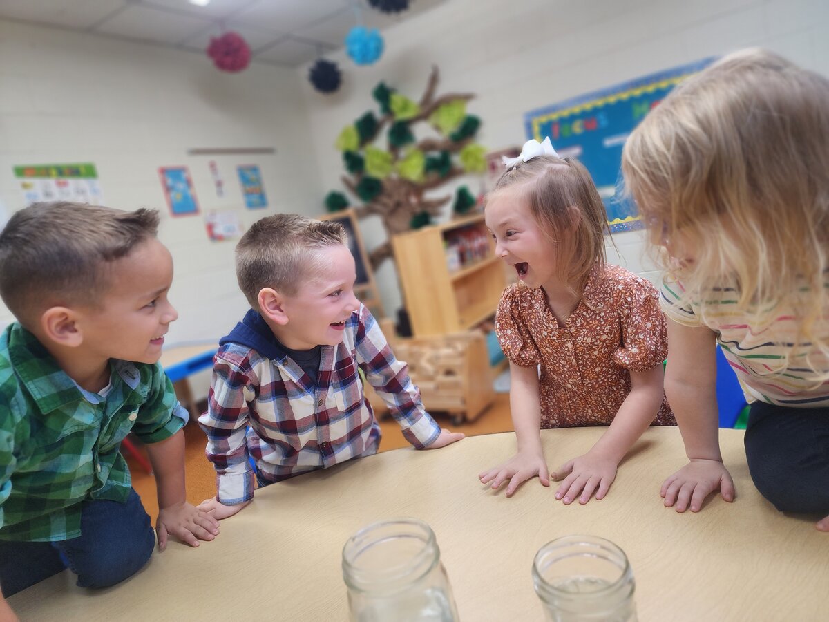 Four students at Bartlett Chapel Preschool have fun together