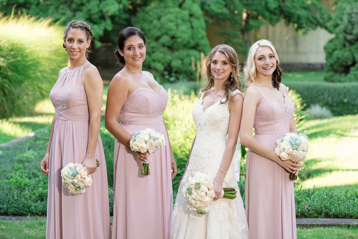 The bridesmaids wearing pink dresses at The Mansion at Oyster Bay