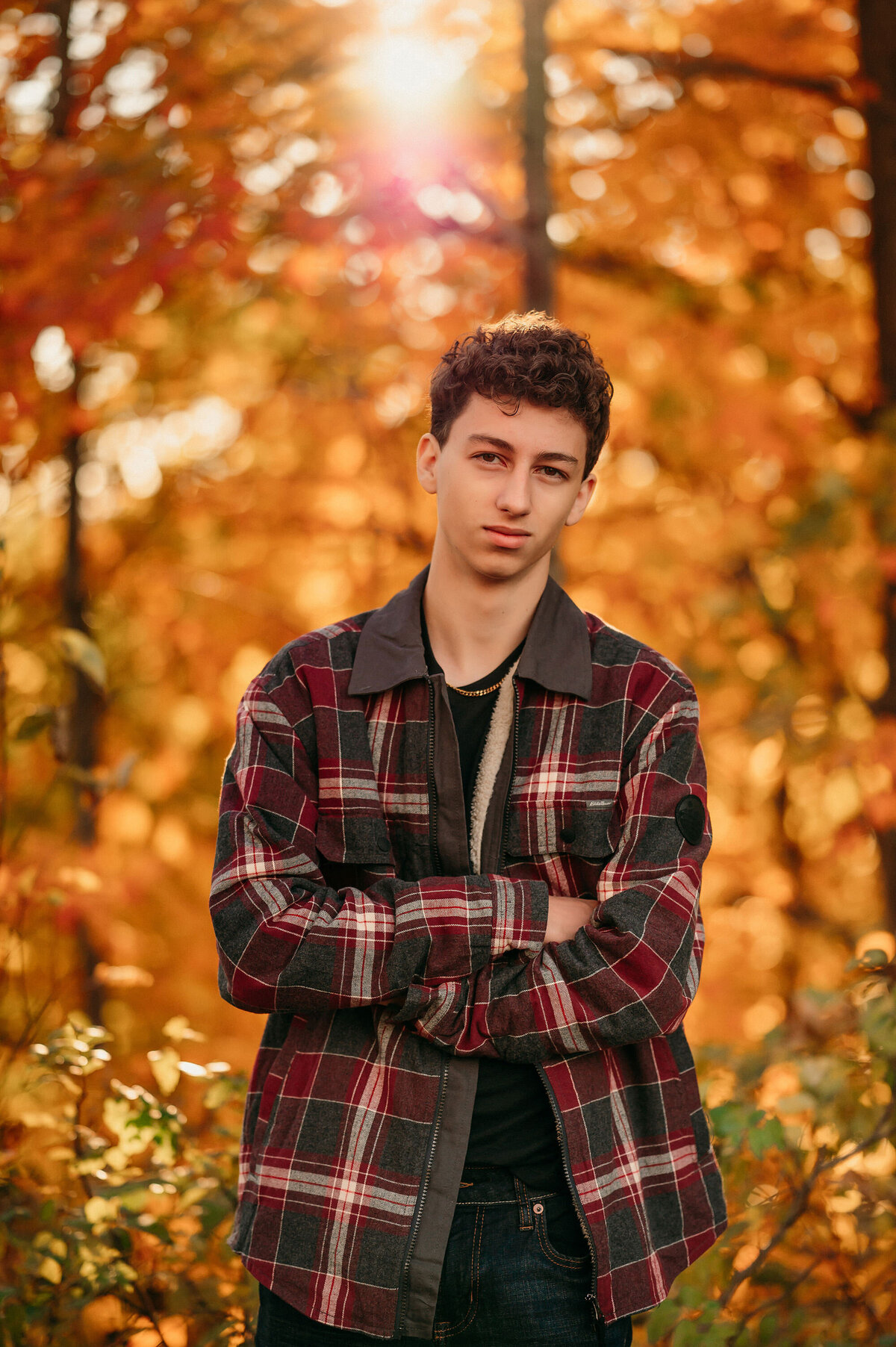 A boy from Oconomowoc High School wears a red flannel jacket surrounded by autumn colors at Delafield's Lapham Peak.