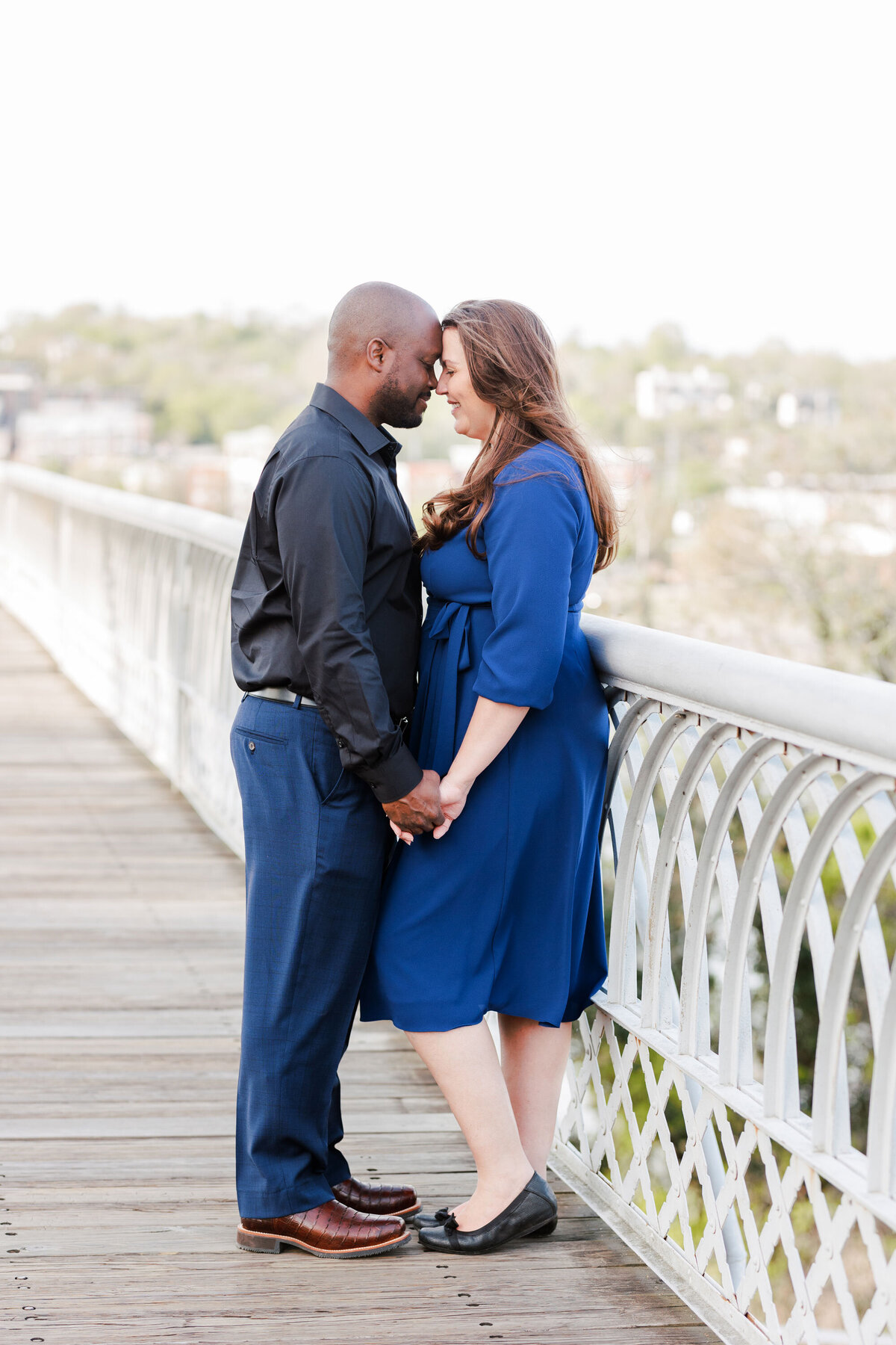engaged couple standing on the Walnut Street Bridge