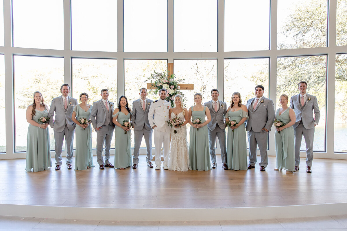 wedding party joins couple at alter indoor large window wall wedding at The Preserve at Canyon Lake Texas