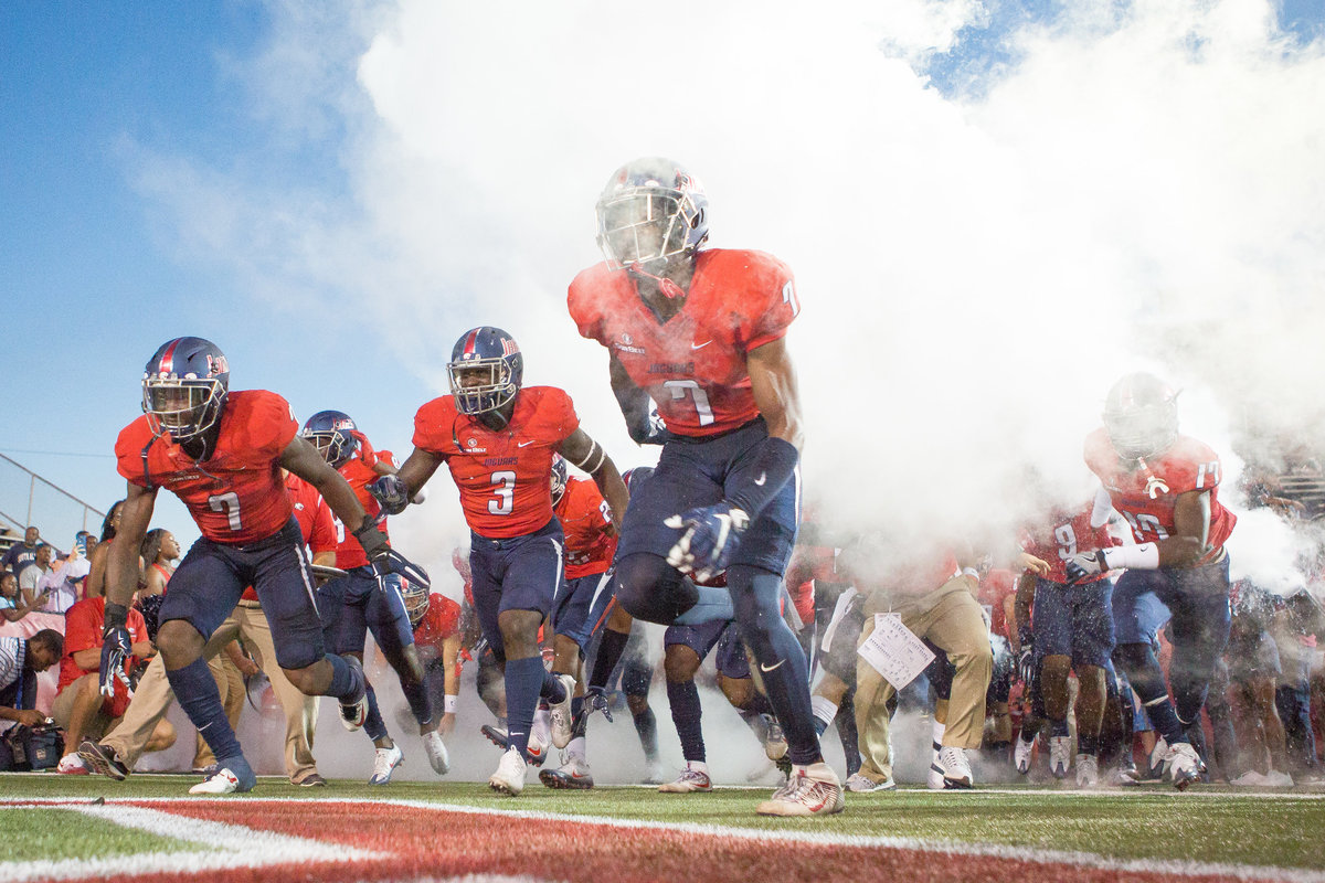University of South Alabama football players taking the field at Ladd Pebbles stadium.