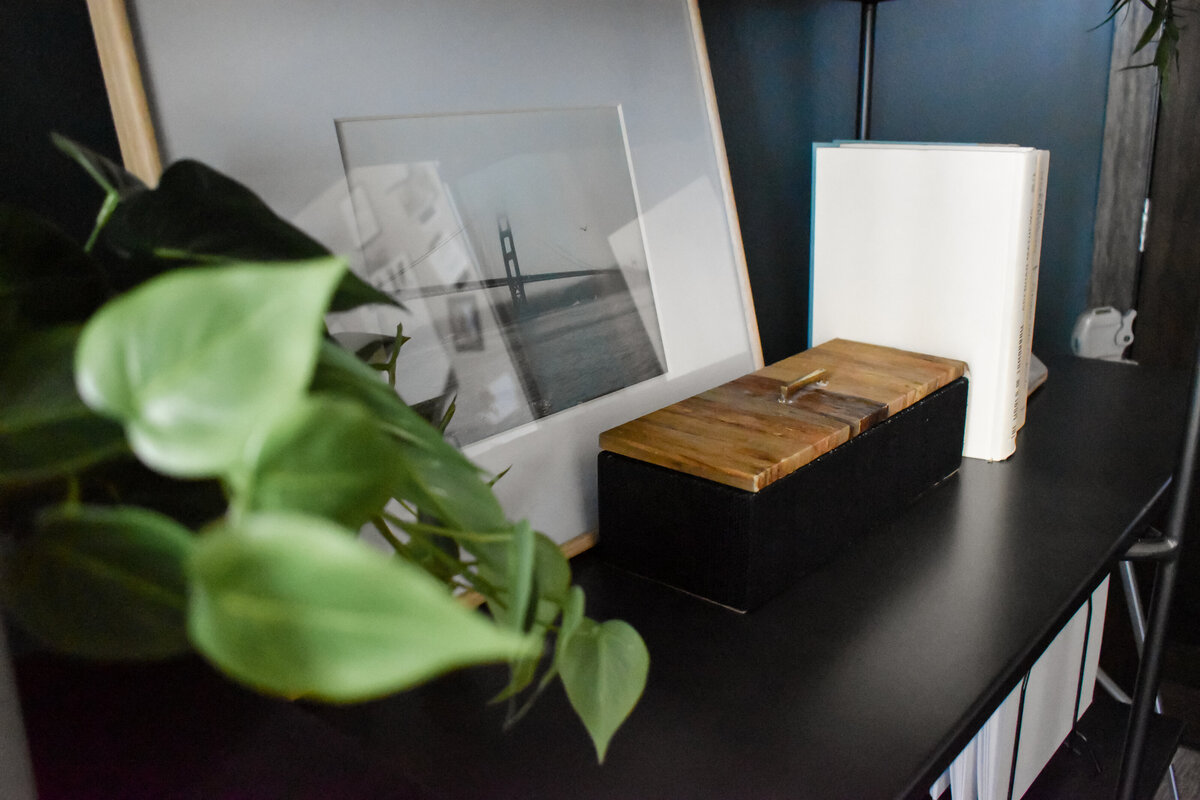 A small keepsake box sits on an office bookshelf