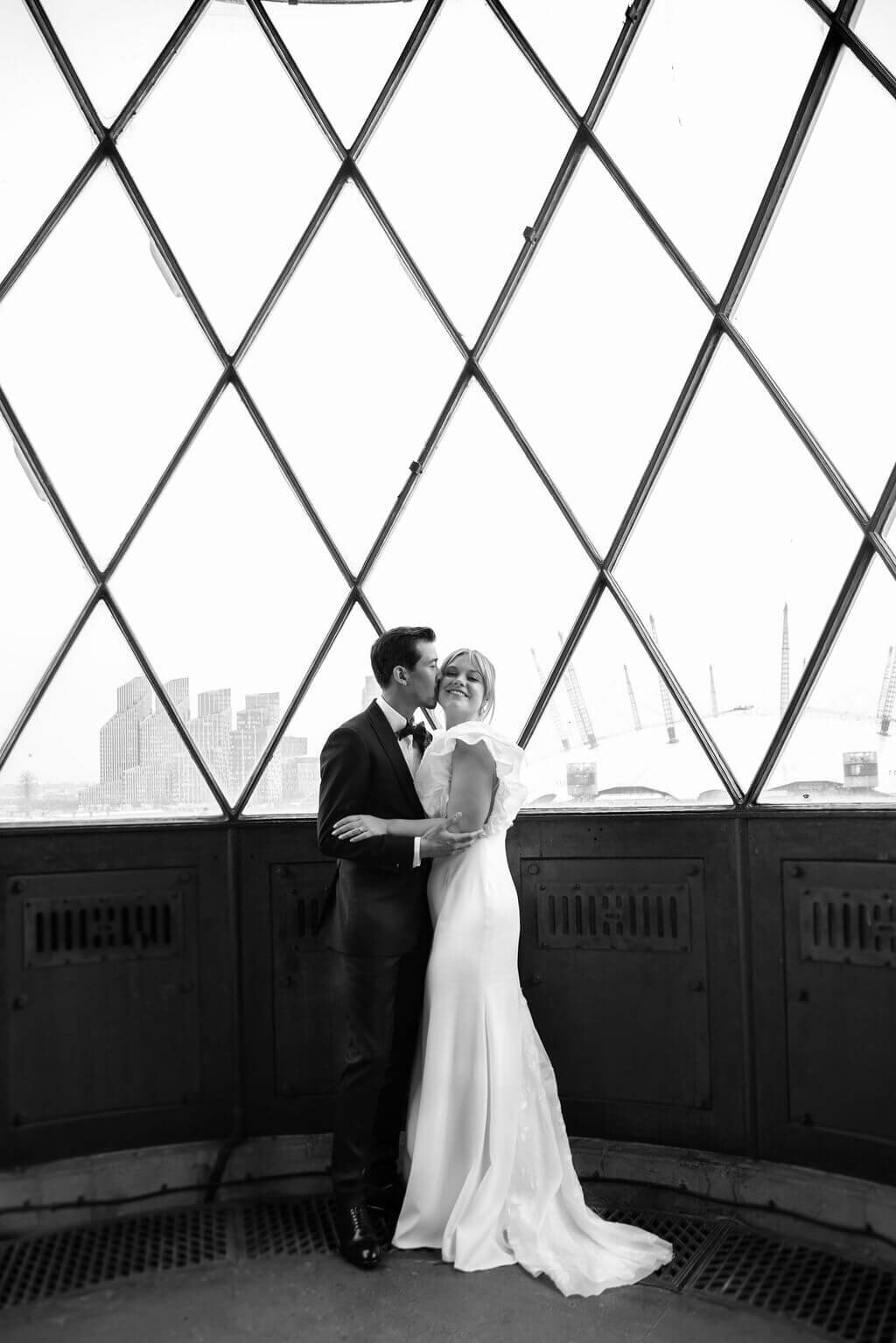 Bride and Groom, in Trinity Buoy Wharf lighthouse .  Bride laughing