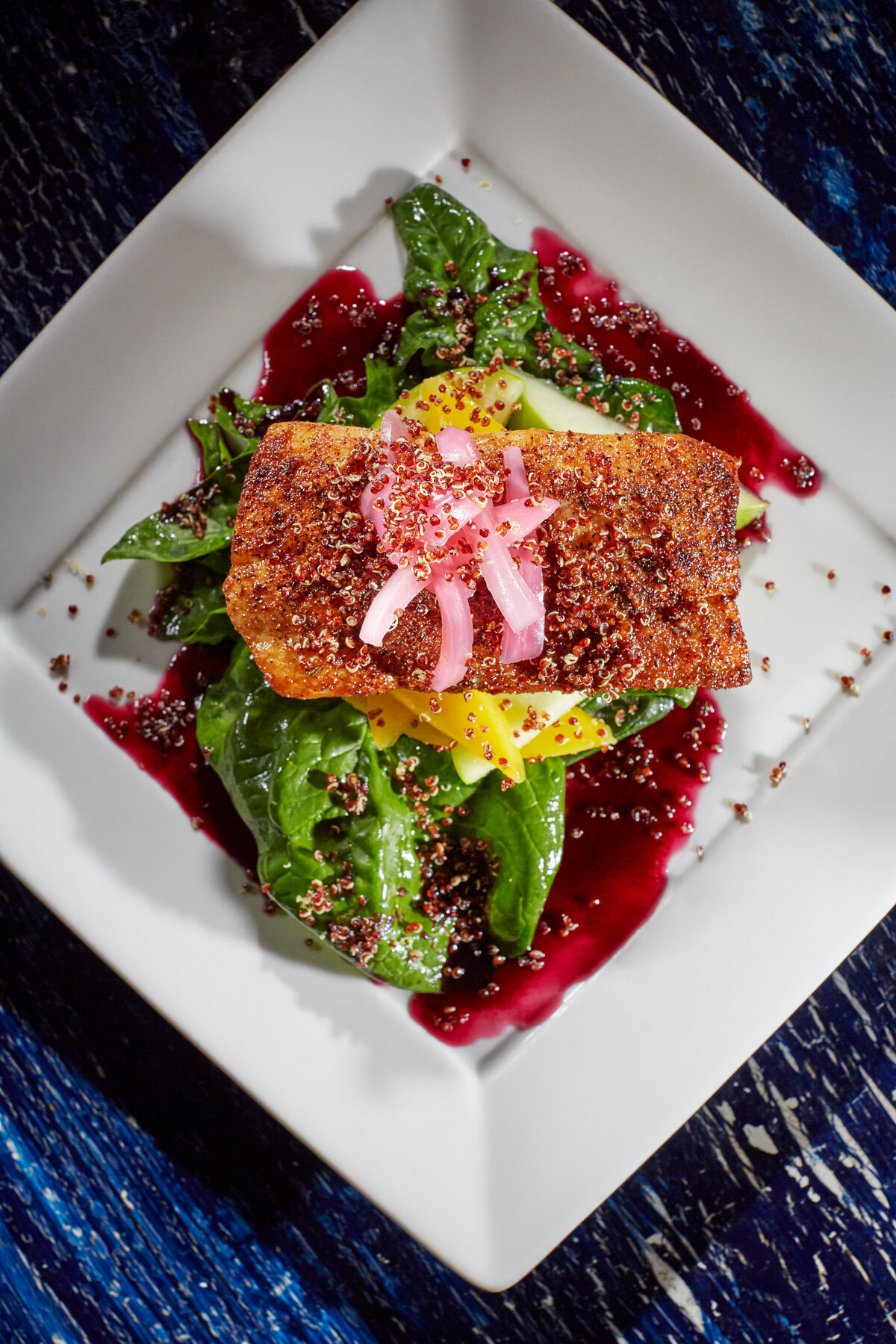 A piece of meat on top of a bed of lettuce