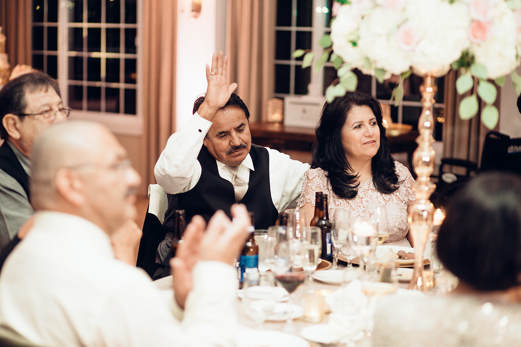 Wedding Photograph Of Man In Black Suit Raising His Hands Beside a Woman in Light Brown Dress Los Angeles