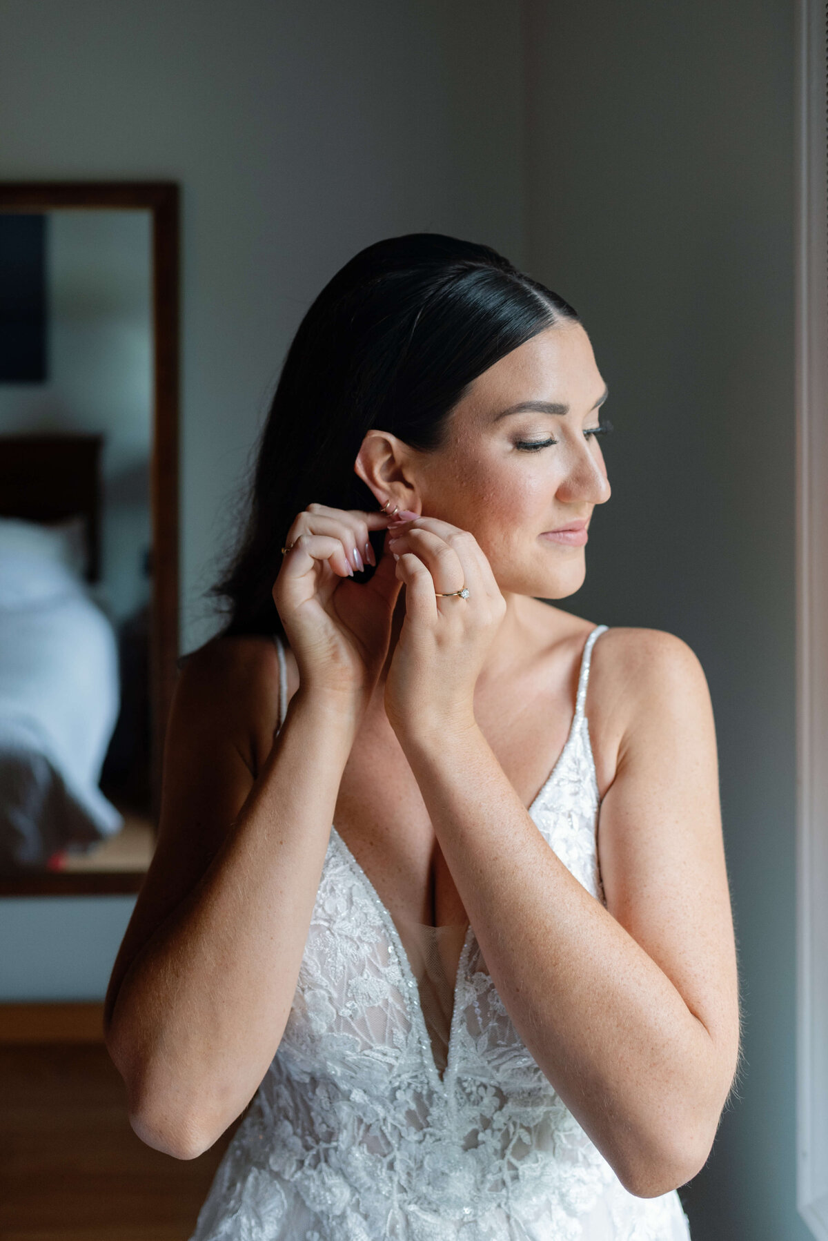 Bride putting earrings in for wedding at Oak Island Resort, Nova Scotia