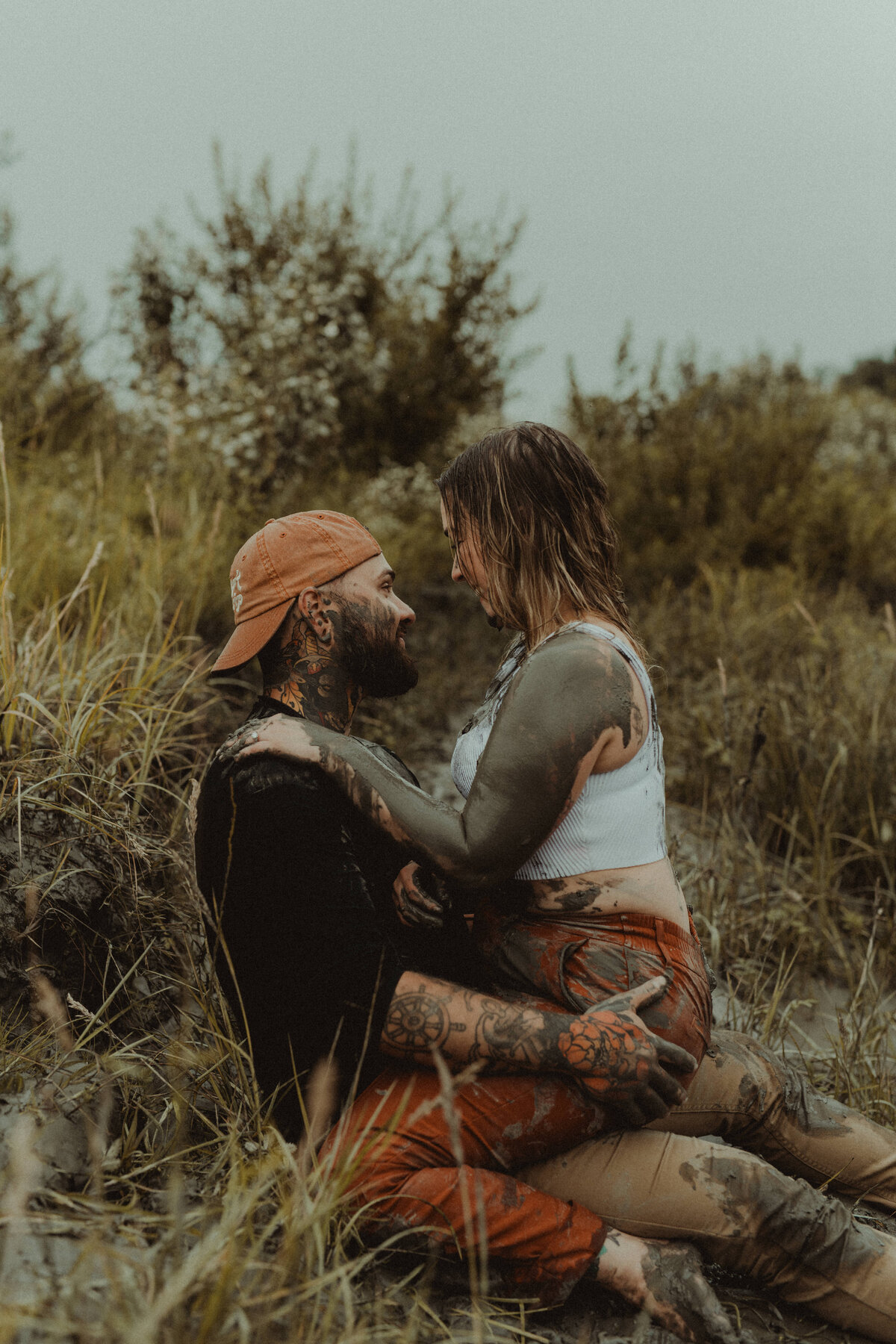 adventurous couples photos during mud fight