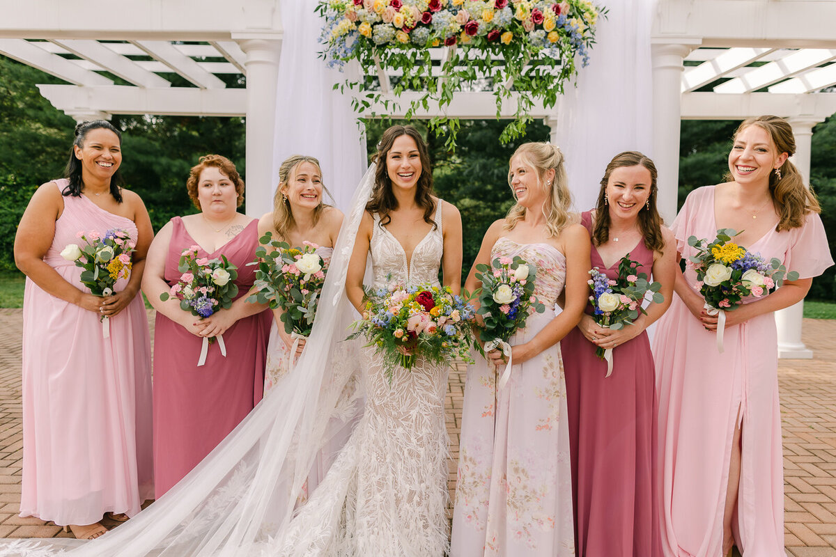 Wedding Photographer, a bride and her bridesmaids stand together