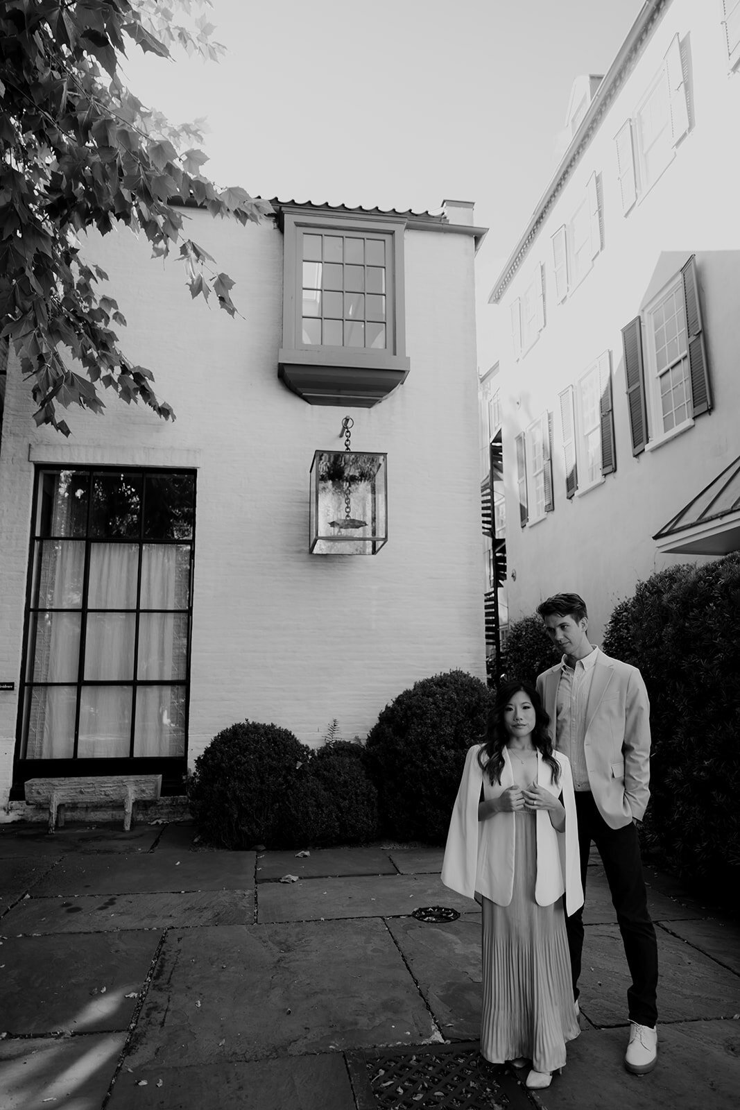 Couple posing in front of building in Business District in Charleston