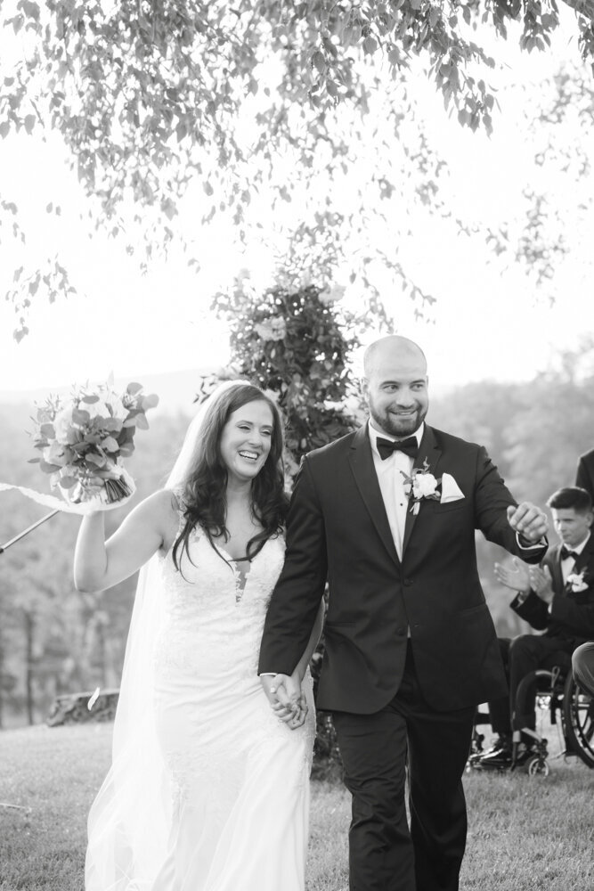bride and groom celebrate walking down the aisle - candlelight farms inn wedding